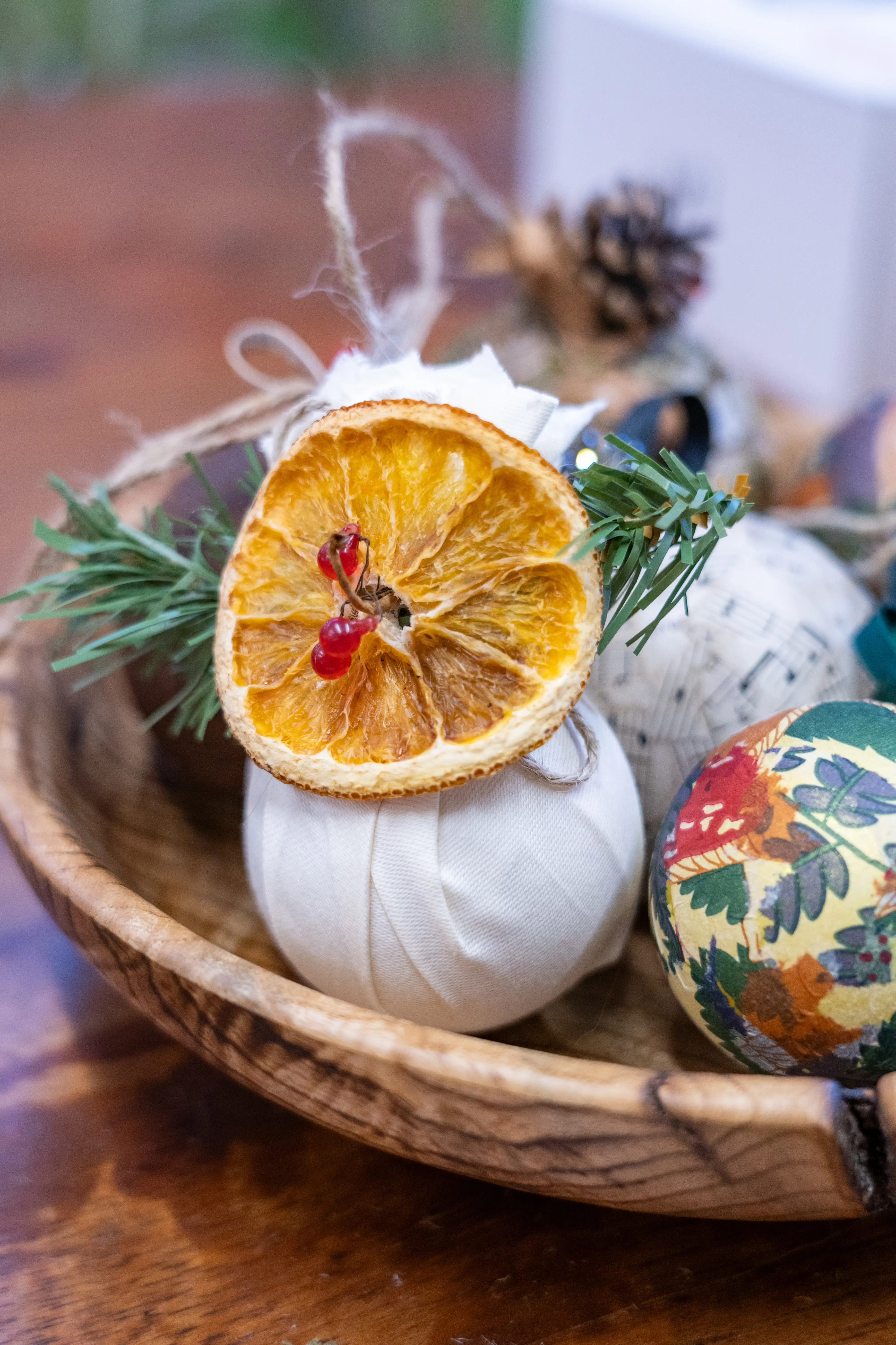 Homemade Christmas Decorations - more baubles in a bowl, with a dried orange slice on top