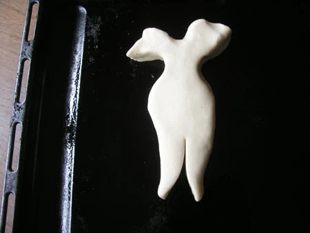 Shaping the dough into an angel